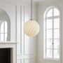 taiseki pendant light with a large Zukr lampshade in a historic French building